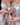 A close-up of Brittany and Briana Murillo’s hands, each holding a bottle of their Mirrored Image Eau de Parfum from Murillo Twins Fragrance.