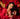 Daisy posed with her signature fragrance, Scarlet, set against a backdrop of red roses and a velvet couch.