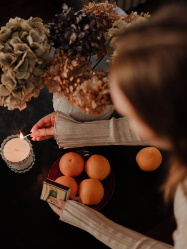 MaCenna Lee, of XO MaCenna, is striking the match and setting aglow the Arlow candle by Auden Lueur.