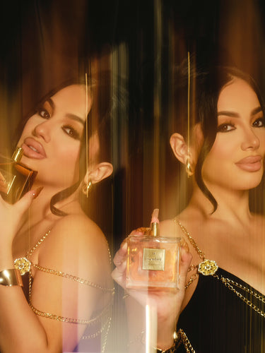 Brittany Murillo holds the Second Self Eau de Parfum up to her nose, smelling its scent, while Briana Murillo spritzes the fragrance with one hand, inhaling the scent from the wrist of her other.