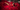 Daisy Marquez lounges on a red velvet couch, surrounded by roses, elegantly posing with her Scarlet Eau de Parfum by Bella Perversa, 2.5 fl oz.