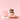 The 3.4 fl oz HeartStone Eau de Parfum and 6.5 oz Scented Candle showcased on a three-tiered stone tower.