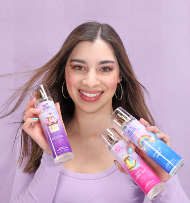 Moriah Elizabeth beams with joy as she proudly showcases her three mists from the ME Scents collection.