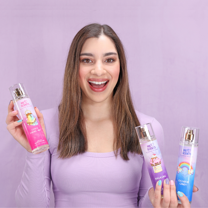 Moriah Elizabeth beams with joy as she proudly showcases her three mists from the ME Scents collection.