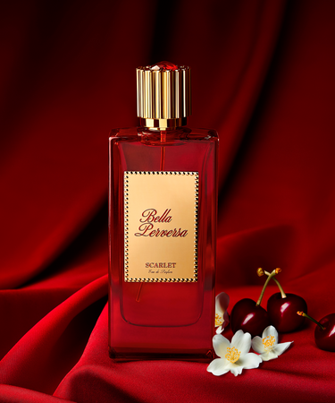 Scarlet Eau de Parfum by Bella Perversa, created by influencer Daisy Marquez, 2.5 fl oz, displayed alongside two of its key notes of bing cherries and jasmine flowers.