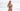 Tracy Anderson stands on a beach, holding her HeartStone Eau de Parfum in her hands.